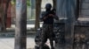 Haitian policemen stand guard on a street corner amid gang violence in Port-au-Prince on April 8,2024.