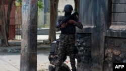 Haitian policemen stand guard on a street corner amid gang violence in Port-au-Prince on April 8,2024.
