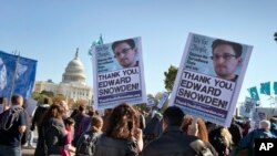 FILE - Demonstrators rally at the U.S. Capitol to protest spying on Americans by the National Security Agency in Washington, Oct. 26, 2013. 