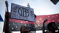 People, holding up a banner that reads in Spanish "We are going for all YPF," demonstrate in support of a bill proposed by Argentina's President Cristina Fernandez. (AP Photo/Natacha Pisarenko)