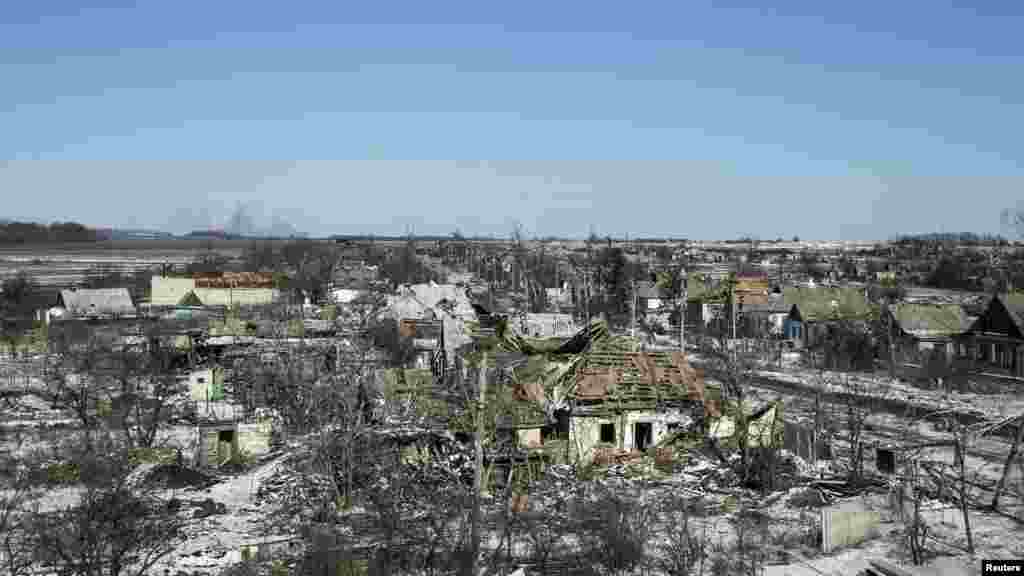 Fighting damaged buildings in the village of Nikishine, southeast of Debaltseve, Ukraine, Feb. 17, 2015. 