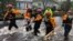 Search and Rescue workers from New York rescue a man from flooding caused by Hurricane Florence in River Bend, North Carolina, U.S. in this Sept. 14, 2018 handout photo. 
