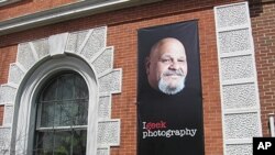 The Rutland Free Library features a large poster of popular local hotdog vendor Lenny Montuori as part of the "Geek the Library" campaign in Rutland, Vermont.