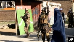 FILE - Afghan security personnel arrive at the site of a bomb explosion in Shakar Dara district of Kabul, Afghanistan, May 14, 2021. 