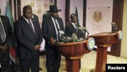 Presiden Sudan Selatan, Salva Kiir (tengah), dan mantan pemimpin pemberontak Riek Machar (kiri) menyerukan ketenangan dalam konferensi pers di Juba, Jumat (8/7).