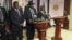 South Sudan President Salva Kiir (C), flanked by former rebel leader Riek Machar (L) and other government officials, addresses a news conference at the Presidential State House in Juba, South Sudan, July 8, 2016. 