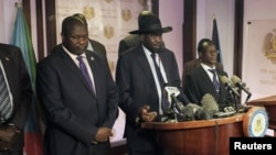 South Sudan President Salva Kiir (C), flanked by former rebel leader Riek Machar (L) and other government officials, addresses a news conference at the Presidential State House in Juba, South Sudan, July 8, 2016. 