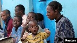 FILE - Patients queue for anti-tuberculosis drugs at the Blue house clinic, run by medical charity Medecins Sans Frontieres (MSF), in the Mathare valley slums of Kenya's capital Nairobi.