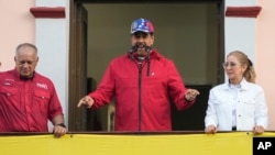 FILE - Venezuelan President Nicolas Maduro speaks to supporters, alongside Interior Minister Diosdado Cabello and first lady Cilia Flores at an event marking the anniversary of the 1958 coup that overthrew dictator Marcos Perez Jimenez, in Caracas on Jan 23, 2025.