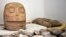 A skull-like stone carving and other parts representing the Flayed Lord are stored after being dug up from the Ndachjian–Tehuacan archaeological site in Tehuacan, Puebla state. This 2018 photo was provided by Mexico's National Institute of Anthropology. 