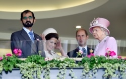 FILE - Sheikh Mohammed bin Rashid al-Maktoum, from left, Princess Haya bint al-Hussein, Britain's Prince Edward and Queen Elizabeth attend Britain's Royal Ascot horse races, June 15, 2016.