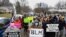 FILE - Protesters gather outside the home where Andre Maurice Hill, 47, was killed in Columbus, Ohio, December 24, 2020. Officer Adam Coy fatally shot Andre Maurice Hill on December 22, 2020, after responding to a nonemergency disturbance call.