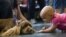 FILE - A cancer patient says hello to a visiting dog at The University of Texas M.D. Anderson Cancer Center, June 10, 2009.