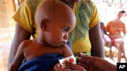 FILE - A child's arm is measured at a center set up by World Food Programme and Action Against Hunger, in the village of Beraketa, in the far south of Madagascar. Nov. 12, 2020. 