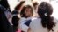 Immigrant families walk to a respite center after they were processed and released by U.S. Customs and Border Protection, June 27, 2018, in McAllen, Texas.