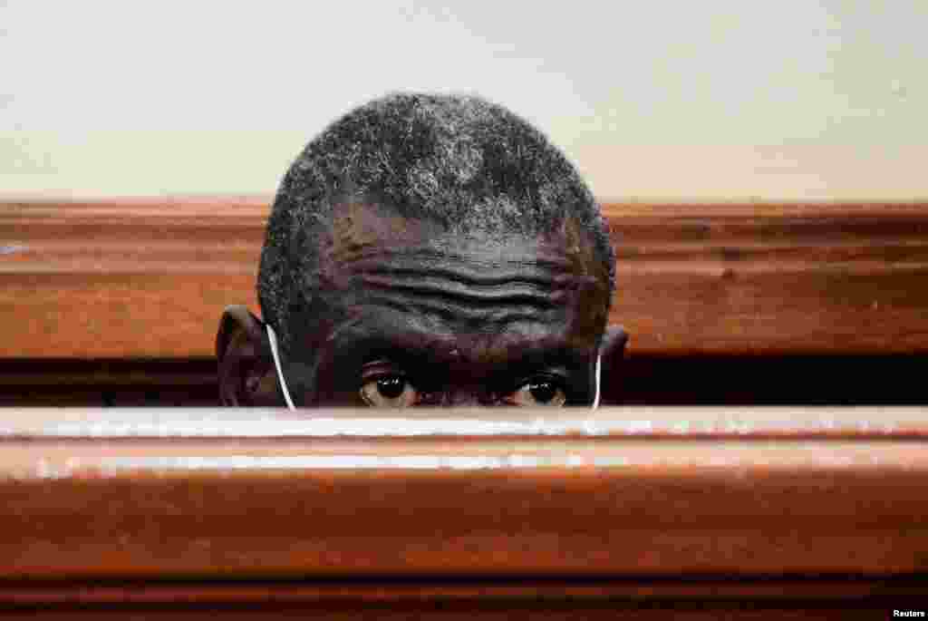 Uganda&#39;s four-time presidential candidate Kizza Besigye sits in the dock where he was charged with treason, at the Chief Magistrate Court in Nakawa suburb of Kampala, Uganda.