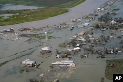 Buildings and homes are flooded in the aftermath of Hurricane Laura, Aug. 27, 2020, in Cameron, La.