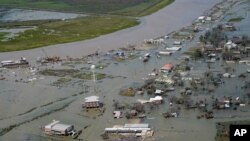 Buildings and homes are flooded in the aftermath of Hurricane Laura, Aug. 27, 2020, in Cameron, La.