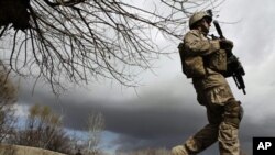 A U.S. Marine from the First Battalion Eighth Marines Alpha Company patrols near the town of Kunjak in southern Afghanistan's Helmand province, Feb. 23, 2011.