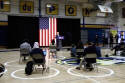Reporters sit socially-distanced as Democratic presidential candidate, former Vice President Joe Biden speaks at Alexis Dupont High School in Wilmington, Del., June 30, 2020.