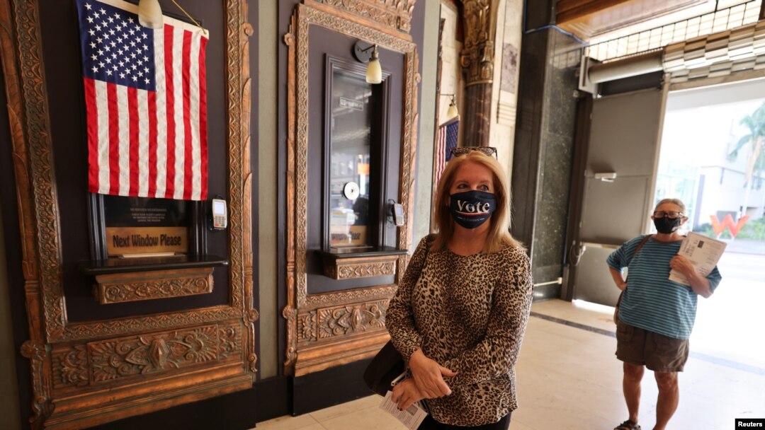 Laura Cohen, 62, waits in line to vote at the Pantages Theater, during the global outbreak of the coronavirus disease (COVID-19), in Hollywood, Los Angeles, California, Oct. 30, 2020. 