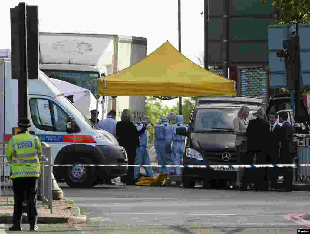 Police forensics officers investigate a crime scene where one man was killed in Woolwich, southeast London May 22, 2013.