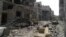 A view shows debris along a street of damaged buildings by what activists said was shelling by forces loyal to Syria's President Bashar al-Assad in Homs, Apr. 8, 2013. 