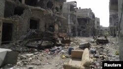 A view shows debris along a street of damaged buildings by what activists said was shelling by forces loyal to Syria's President Bashar al-Assad in Homs, Apr. 8, 2013. 