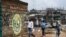 A young boy reads out the message from an informational mural warning people about the risk of COVID-19 in a slum in Nairobi, Kenya, April 22, 2020. 
