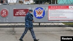 An officer walks outside the IK-3 penal colony, which houses a hospital where jailed Kremlin critic Alexey Navalny was reportedly transferred, in Vladimir, Russia, April 20, 2021.