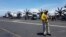 An air traffic controller guides aircraft landing on the deck of the USS Theodore Roosevelt, transiting the South China Sea April 10, 2018. 