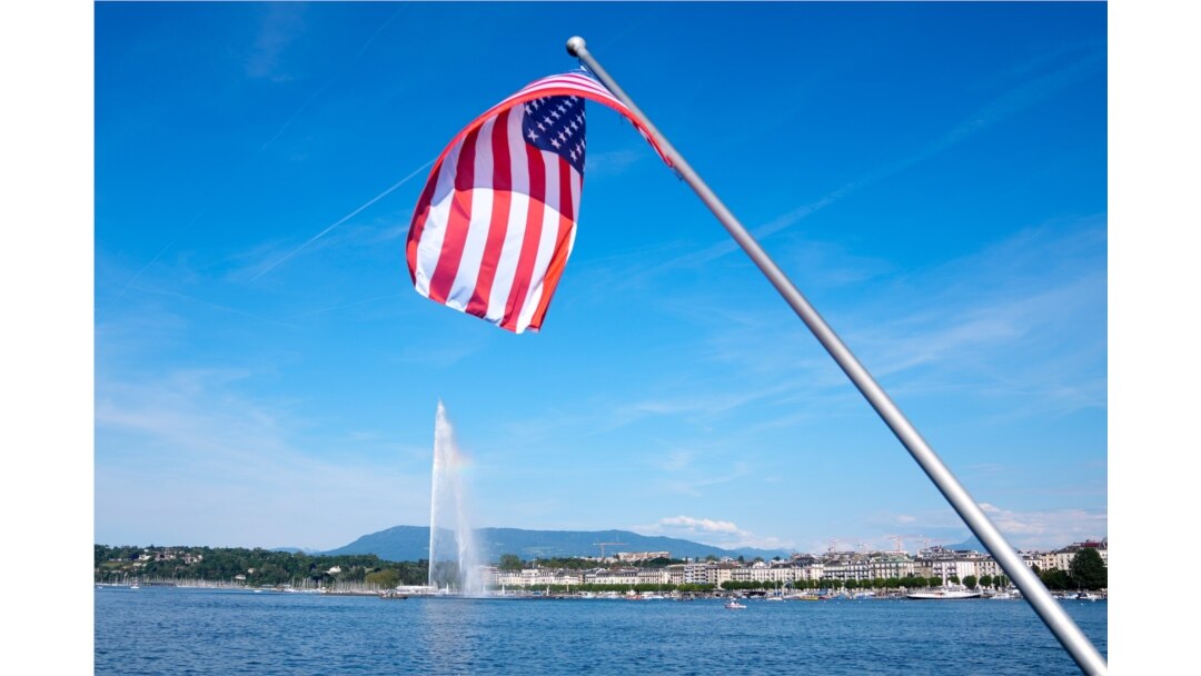 The United States flag waves on a bridge near the fountain Jet d'eau in the Lake Geneva in Geneva, Switzerland, June 15, 2021.