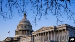 The Capitol and Senate are seen at sunrise on the first full day of the impeachment trial of President Donald Trump on charges of abuse of power and obstruction of Congress, in Washington, Jan. 21, 2020. 