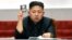 North Korean leader Kim Jong Un holds up his ballot during the fifth session of the 12th Supreme People's Assembly of North Korea at the Mansudae Assembly Hall in Pyongyang April 13, 2012.