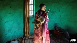 FILE - Traditional Xhosa initiate Fezikhaya Tselane, 20 years old, stands during a traditional initiation process in a rural hut in the Coffee Bay area in Umtata, South Africa, July 11, 2017.