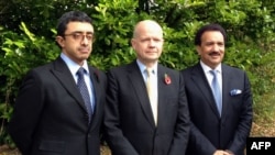 British Foreign Secretary William Hague (C), Emirati Foreign Minister Sheikh Abdullah bin Zayed al-Nahayan (L) and Pakistani Interior Minister Rehman Malik (R) posing for a picture during their visit to the Queen Elizabeth Hospital, where shot Pakistani schoolgirl Malala Yousafzai is receiving treatemnt, October 29, 2012. 