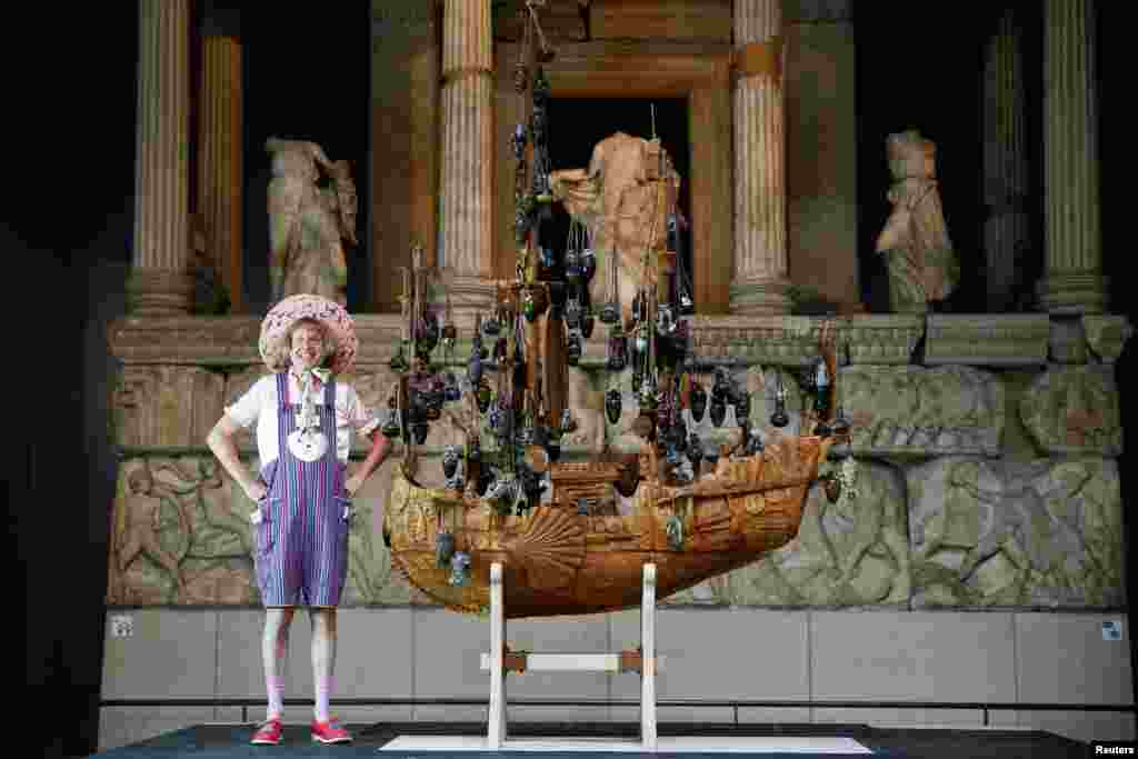 British artist Grayson Perry poses next to his work of art entitled &#39;The Tomb of the Unknown Craftsman&#39;, on display at the British Museum, in London.