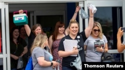 Advocates from the United States exit a Canadian pharmacy after purchasing lower-cost insulin in London, Ontario, June 29, 2019. 