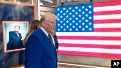 US President-elect Donald Trump arrives on the floor of the New York Stock Exchange after ringing the opening bell, Dec. 12, 2024, in New York. 