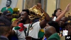 South Africa's Springboks captain Siya Kolisi holds the Webb Ellis trophy as fans welcome the team upon arrival at O.R Tambo International Airport in Johannesburg, South Africa, Oct. 31, 2023, after the Rugby World Cup.