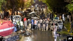 Security officers examine the site of an explosion outside Karachi airport, in Karachi, Pakistan, Oct. 7, 2024. 