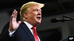 President Donald Trump speaks at a rally in Council Bluffs, Iowa, Oct. 9, 2018. 