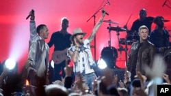 Nick Carter, from right, of Backstreet Boys, and from left, Tyler Hubbard, and Brian Kelley, of Florida Georgia Line, perform at the 52nd annual Academy of Country Music Awards at the T-Mobile Arena, April 2, 2017, in Las Vegas, Nevada.