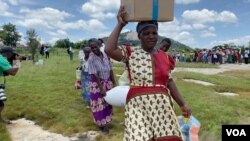 Food-insecure women leave a World Food Program relief center in Mudzi district, Zimbabwe, about 200 km east of Harare, Feb. 2020 (Columbus Mavhunga/VOA)