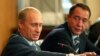 FILE - Russian President Vladimir Putin, left, gestures as Mass Media Minister Mikhail Lesin listens to him during a meeting with local press in the far eastern city of Vladivostok, Aug. 24, 2002