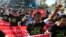 FILE - Reporters shout as they march demanding broader press freedom in Yangon, Myanmar, Jan. 7, 2014. A similar protest is planned for Thursday when two prominent journalists are to go on trial for alleged defamation.