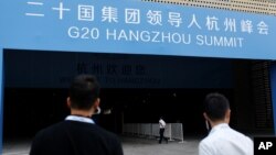 Security personnel patrol in front of the entrance of a conference centre, where the G20 summit will be held, in Hangzhou, Zhejiang Province, China, Sept. 1, 2016. 