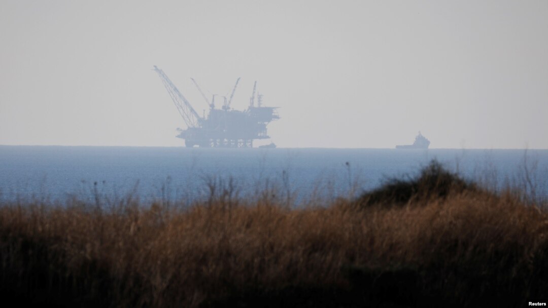 FILE - An Israeli navy boat is seen next to the production platform of Leviathan natural gas field in the Mediterranean Sea near Kibbutz Nahsholim in northern Israel Dec. 18, 2019.