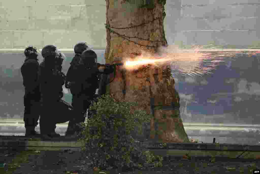 Police fire tear gas toward protesters during the fifth straight night of demonstrations against the government&#39;s postponement of EU accession talks until 2028, in central Tbilisi, Georgia.