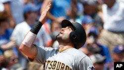 Pittsburgh Pirates' Francisco Cervelli celebrating after hitting a grand slam against the Chicago Cubs during the first inning of a baseball game in Chicago, July 9, 2017. Amid three months of often-violent confrontations and economic turmoil in their cou
